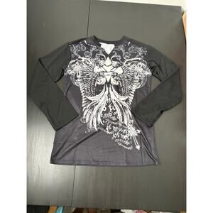 Long sleeve tunic decorative with cross and wings.